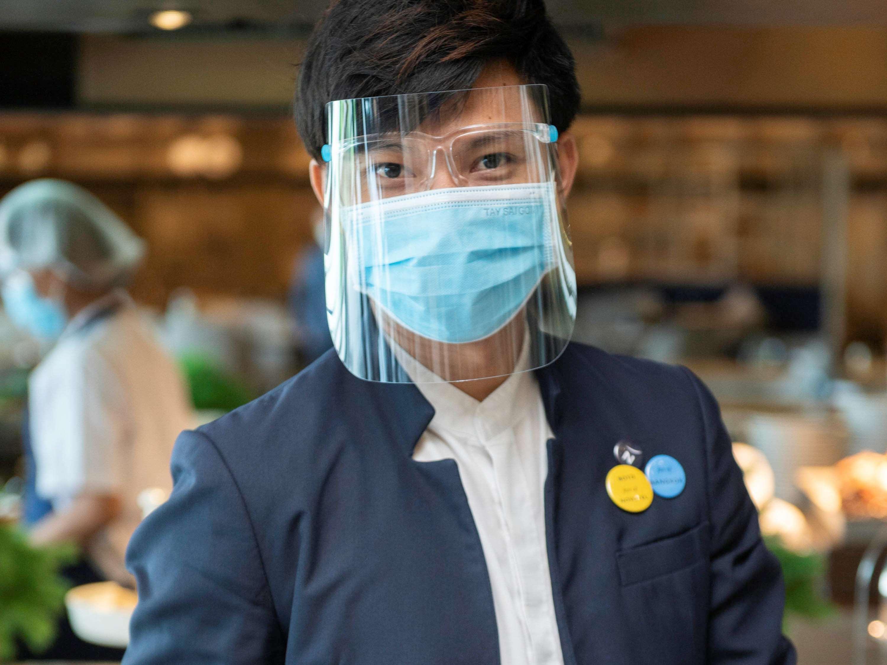 Novotel Chennai Sipcot Exteriör bild A Thai Airways employee wearing a face shield